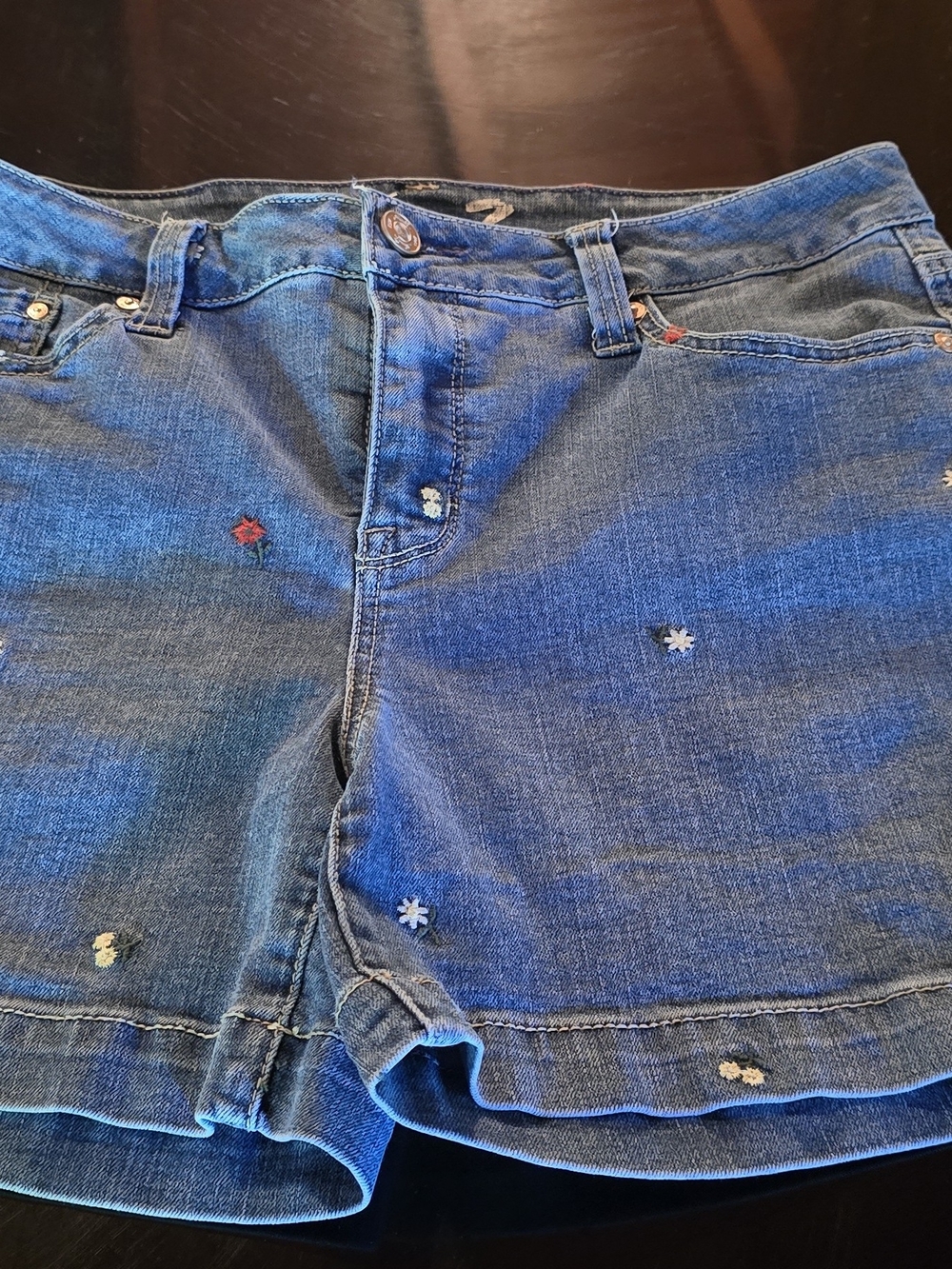 Seven7 brand women's denim shorts featuring small embroidered flowers throughout